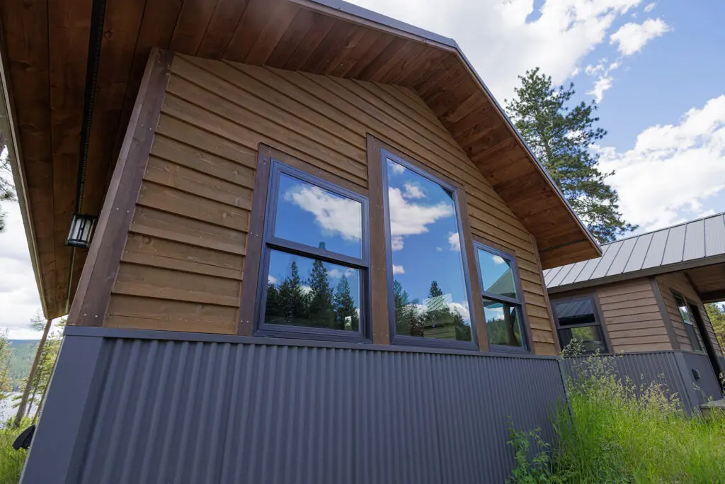 Cabin exterior with wood siding and large windows