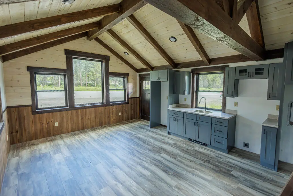 Panoramic cabin interior with kitchen and living area