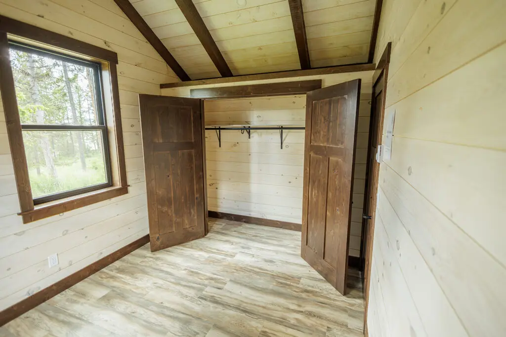 Cabin interior with wood walls, wood flooring and built-in storage