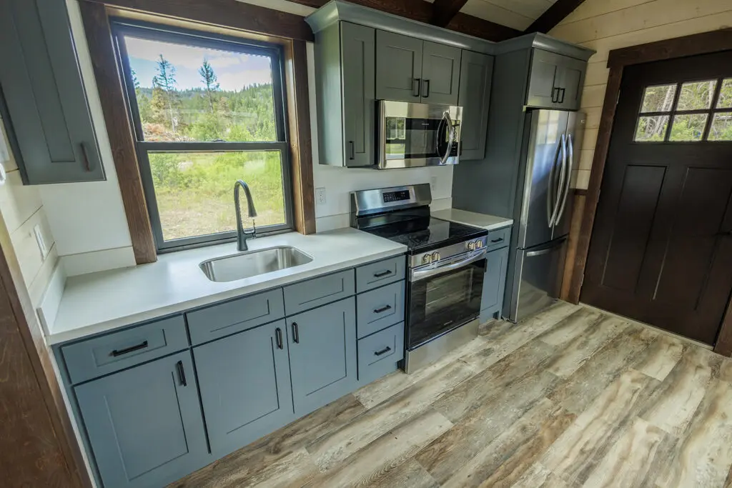 Cabin kitchen with vaulted timber door and floor
